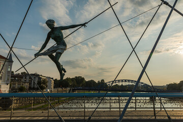 A sculpture of a human figure balancing on the ropes.