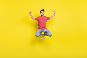 Fototapeta na wymiar Full length photo of hooray beard young guy jump wear red t-shirt jeans footwear isolated on yellow background