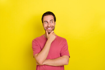 Photo of clever guy finger chin look empty space dream wear pink t-shirt isolated yellow color background