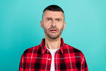 Fototapeta premium Photo of scared millennial brunet guy wear red shirt isolated on teal color background