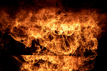 Blaze fire flame texture background,Light and life,Fiery orange glowing flying away particles over...