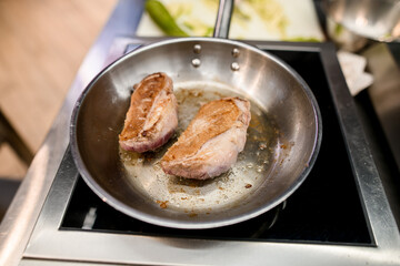 selective focus on delicious fried chicken fillet in a skillet