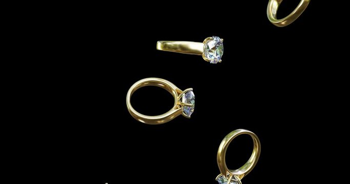 3d animation of the smooth fall of gold rings with a diamond, crystal . Costume jewelry, shiny, sparkling, gemstone.