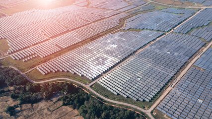 Aerial drone view of solar panels at a solar energy generation farm at Sunset. aerial view of a large solar farm