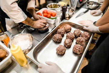 metal baking sheet on which the minced meat balls lie