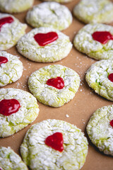 Grinch holiday cookies with powered sugar and red hearts
