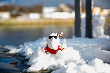 Cool funny Santa Claus with sun glasses on the snow 