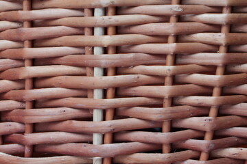 Old brown rural wicker basket fragment closeup - natural rustic woven surface background texture