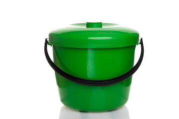 green plastic bucket with lid on white background