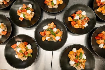 beautiful top view on plates with salad of basil mozzarella tomatoes and pieces of baguette