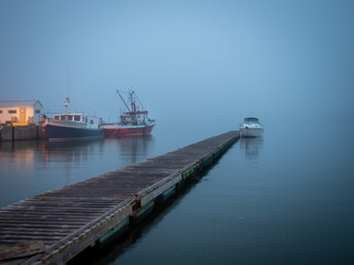 Boat on the St-Laurence river at blue hour at Trois-Pistol harbour in Gaspesie