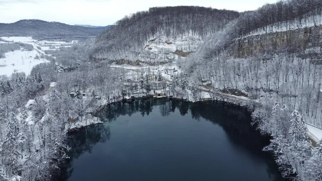 drone flight over a mountain lake in winter