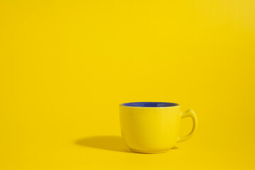 yellow cup of coffee on a yellow background

