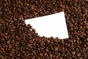 Creative layout made of coffee beans. Coffee card. Coffee background with paper card.