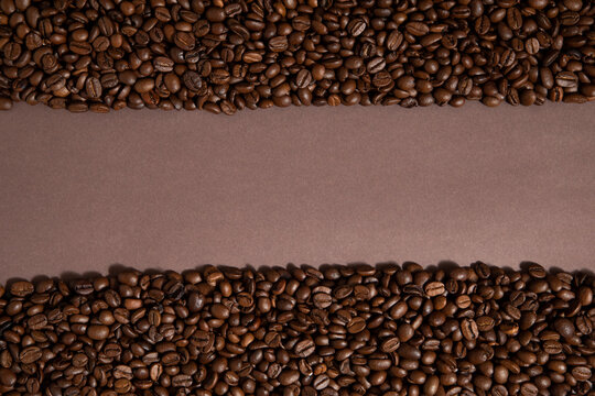 Tape, like road made of caffee beans. Brown background. © Amar