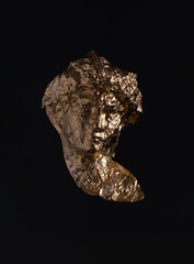 Gold tin foil shaped like classic antique sculpture against dark background. Popular, cultural...
