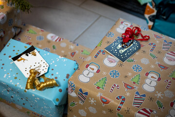 Fototapeta premium Festive wrapped Christmas gifts and Christmas presents under the xmas tree shows decorative unboxing event with traditional celebration of handmade winter season for sparkling children eyes beauty