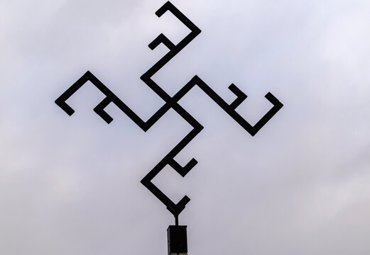 Photo of iron thunder cross silhouette against dramatic sky.