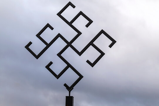 Photo of iron thunder cross silhouette against dramatic sky.