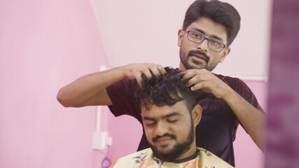 Relaxed enjoying customer getting head massage from professional barber at salon - concept of refreshment, relaxations, hair care or stress relive treatment or therapy.