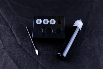 on the black sheet there is a stand with capsules for pigment for permanent eyebrow makeup