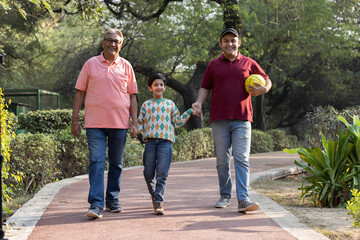 Cheerful three generation Indian family having fun together at park