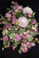 flower bouquet arrangement in pink purple tones with roses, chrysanthemums, cymbidium orchids,...