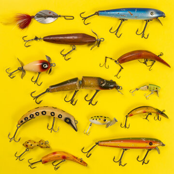 Retro fishing lures against yellow background