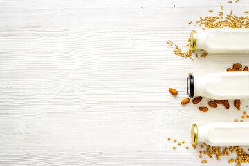 Dairy free substitute milk with nuts and cereals, top view