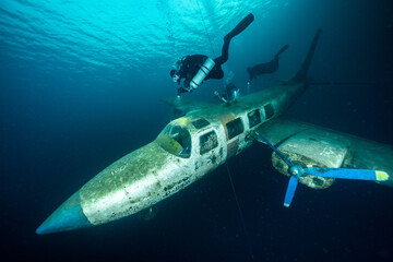 Scuba diver exploring plane wreck in Kreidesee Hemmoor quarry