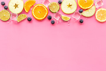 Slices citrus fruits and berries with with ice for making cocktail or juice