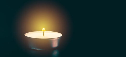 background with candle and bright flame, religious postcard