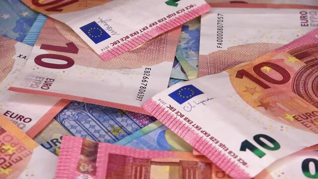 Loopable close up of numerous euro banknotes lying on top of each other  on a spinning plate.
