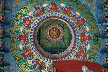 Nonthaburi, Thailand - 26 Dec 2021 : Abstract ceiling design inside the architecture of chinese style temple in Wat Borom Racha Kanchana Phi Sek Anuson (Wat Leng Noei Yi 2). Bottom view, Selective foc