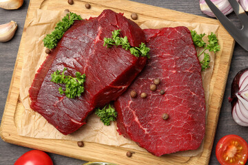 Concept of cooking with raw steak on wooden background
