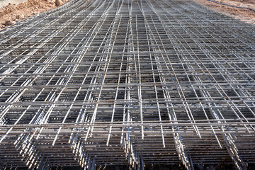 Steel grating is prepared to make cement floors for construction