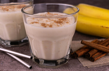 Banana cinnamon smoothie in a glass.
Close-up.