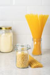 Gluten free pasta in a glass jar on the table. Pasta made from corn and rice flour for diet food.