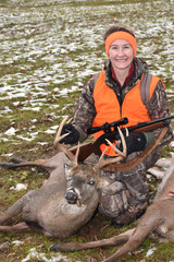 A proud hunter with a trophy white-tailed buck.