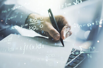 Creative scientific formula illustration with hand writing in diary on background with laptop, science and research concept. Multiexposure