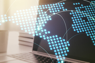 Abstract creative world map with connections on modern laptop background, international trading concept. Multiexposure