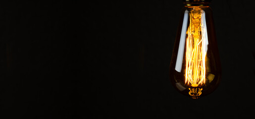 Bulb. Edison's light bulb. Desk lamp. Against a dark background. Black
