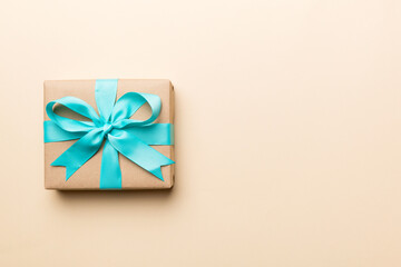 Holiday present box over colored background, top view. Copy space for design