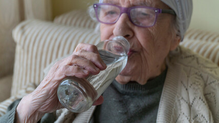 senior person drinking water