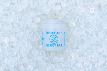 Small plastic container that contains silica gel crystals. It is a desiccant