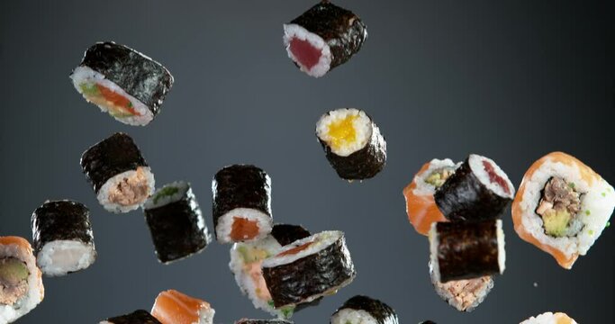 Super slow motion of flying sushi pieces on black background. Filmed on high speed cinema camera, 1000fps