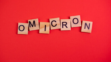 Obraz premium Omicron variant displaces Delta. Emergence of new dangerous strain of coronavirus COVID-19 Omicron. Words omicron on colored red background