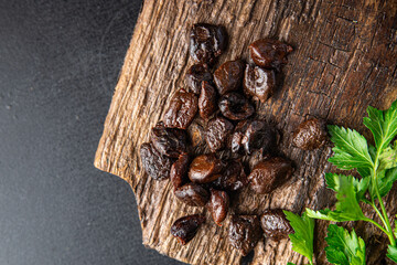 sun-dried olives smoked pitted olive fruit healthy meal food snack on the table copy space food background rustic top view keto or paleo diet veggie vegan or vegetarian food