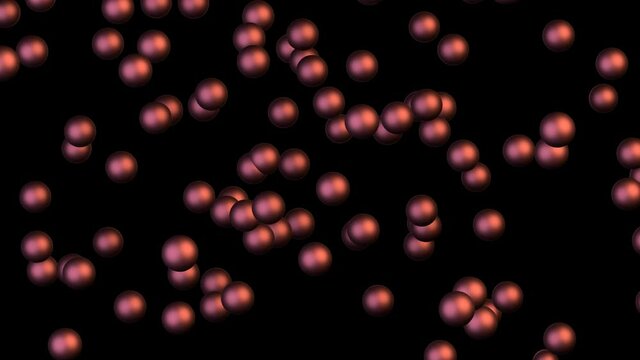Chaotic Brownian motion of copper balls on a black background. The erratic movement of red balls in the dark.