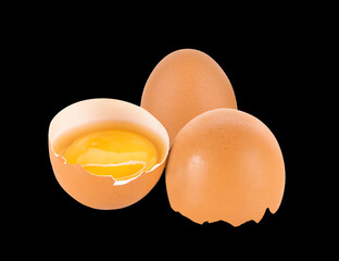 Broken egg isolated on black background.